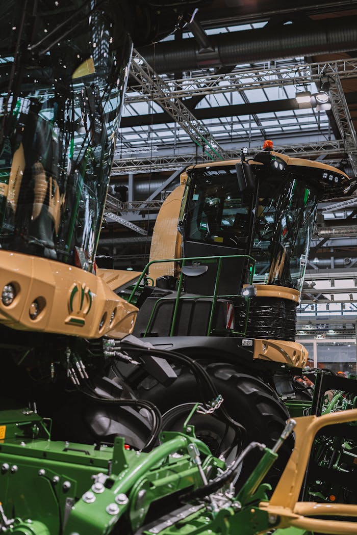 Close-up of advanced agricultural machinery displayed at an indoor exhibition, showcasing modern farming technology.