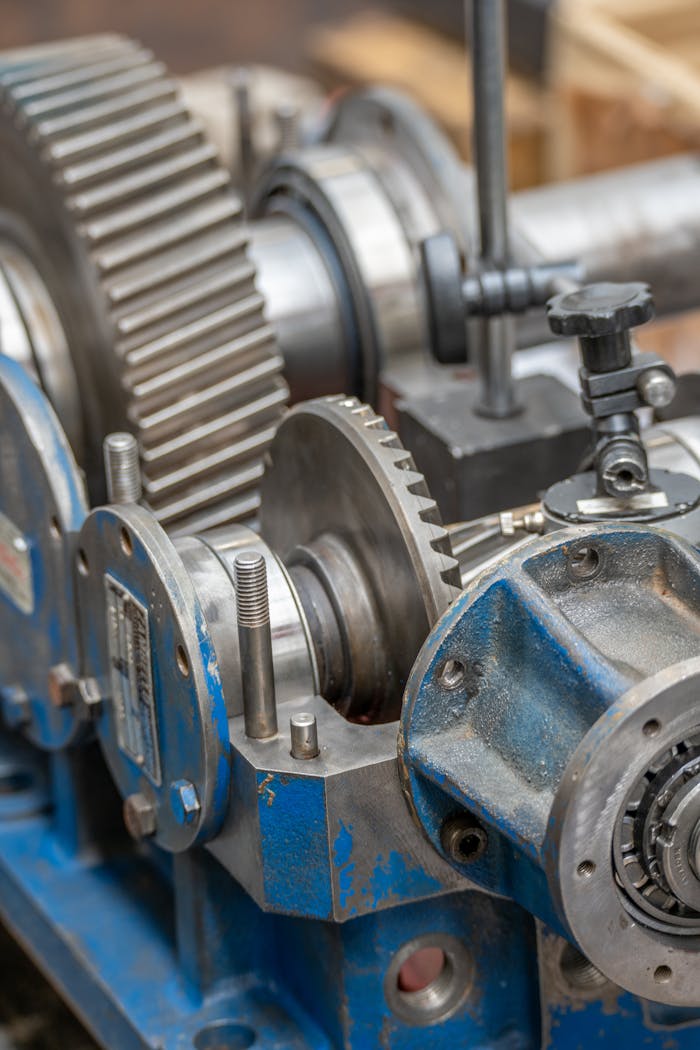 Detailed view of gears and metal components in an industrial setting.
