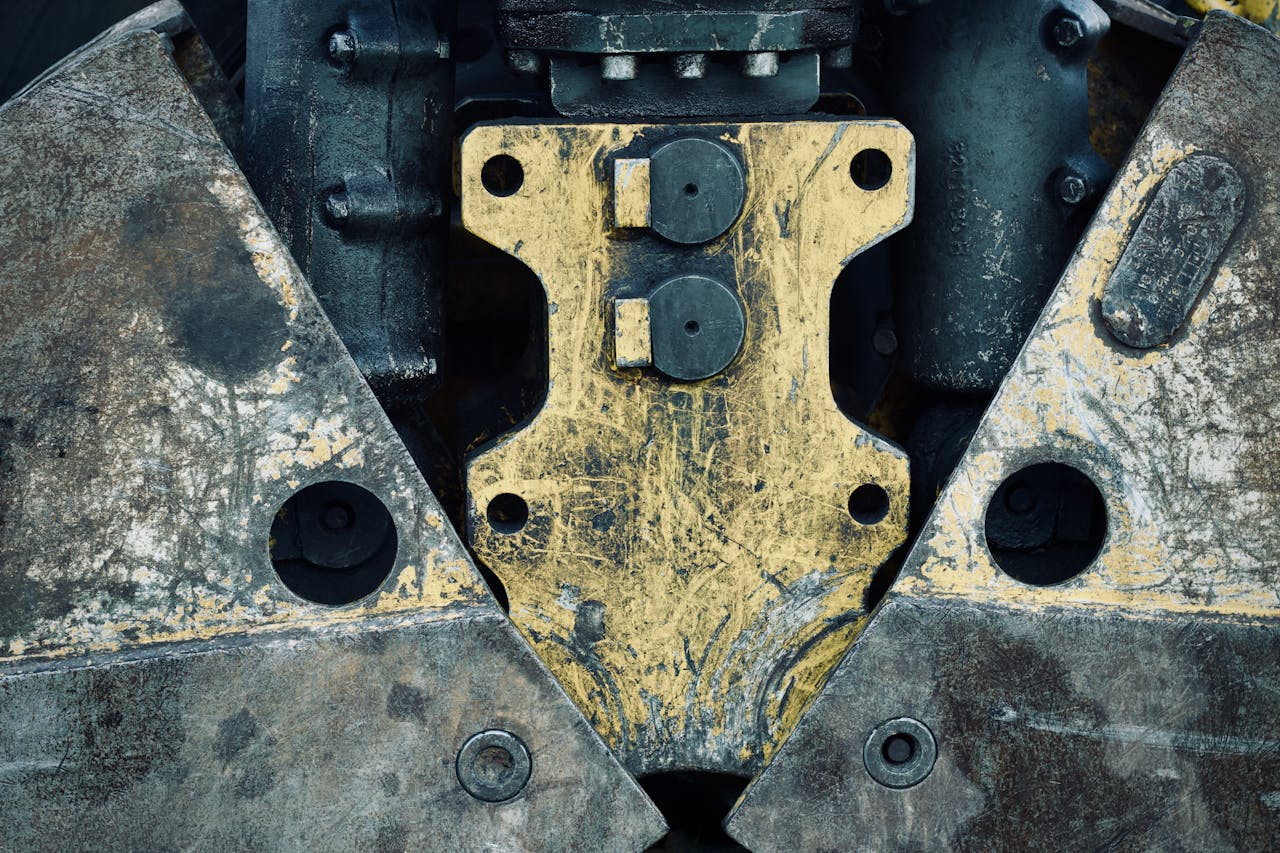 Close-up of aged metal machinery parts showcasing a rugged industrial design.